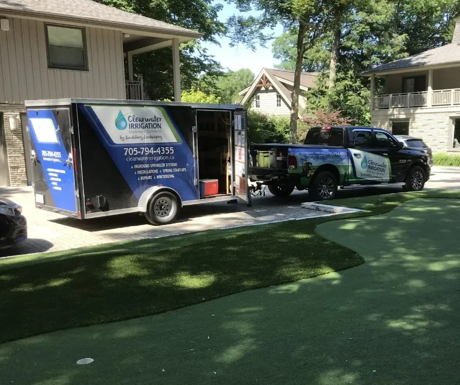 The Clearwater Irrigation branded truck and trailer parked on a freshly watered lawn